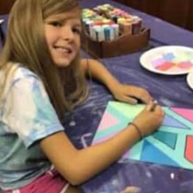 Child painting in a class