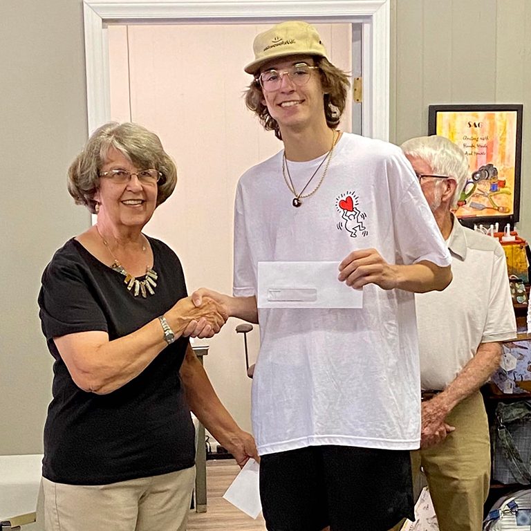 Guild member presenting to scholarship recipient